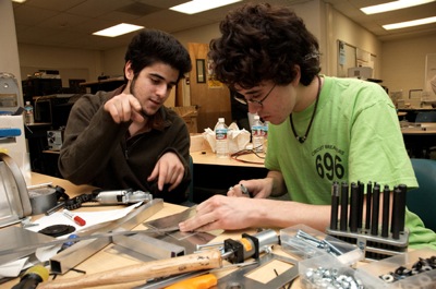Will and Areg work on assembling the arm
